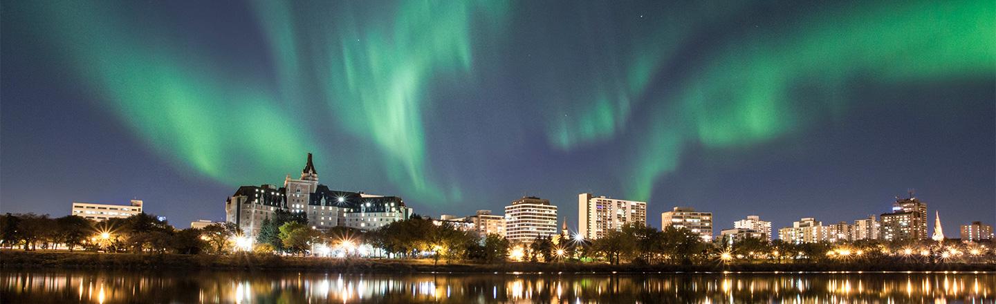 city skyline with the northern lights overhead