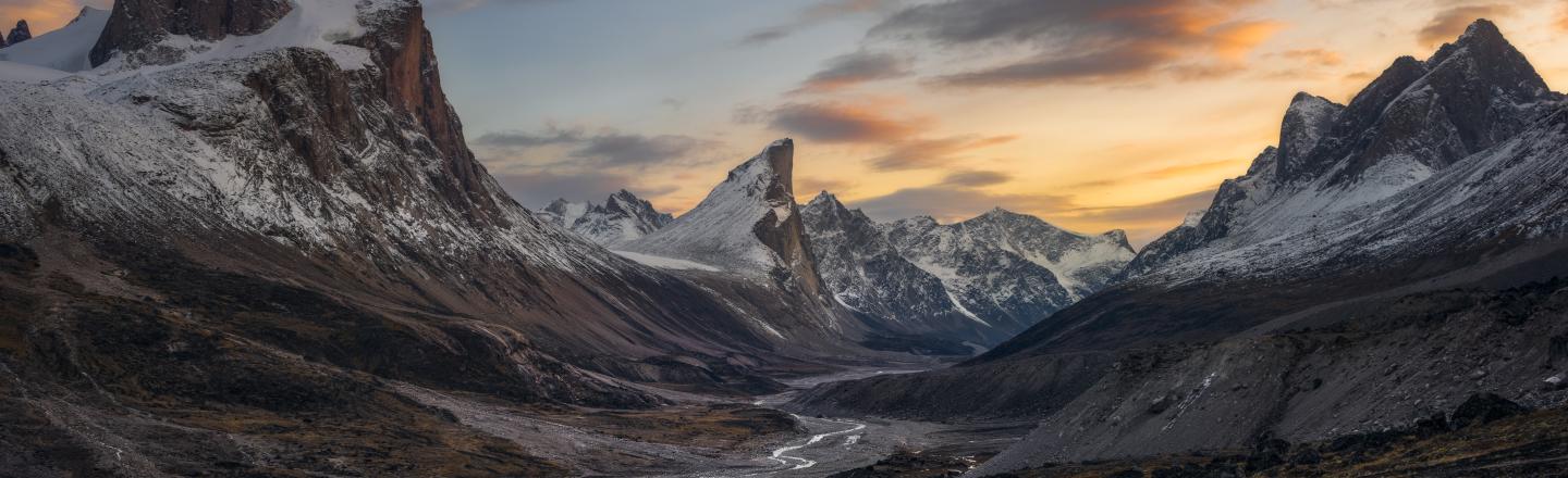 Snow-covered mountains and sunset skies